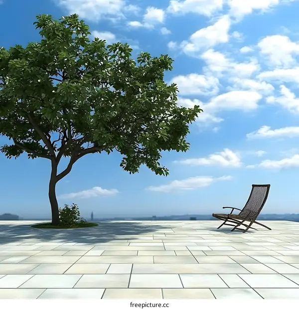 Green Tree with a Chair in Front of a Cloudy Sky