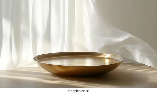 Golden Bowl Against Sheer Curtains