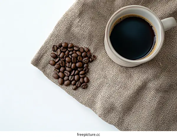 Coffee Beans and Cup of Black Coffee on Burlap Fabric