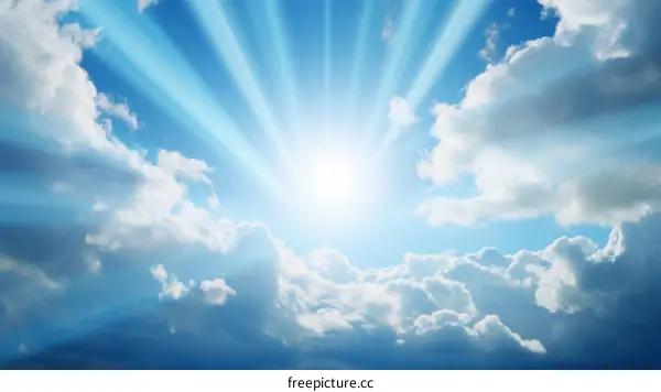 Blue sky with sun rays shining through white clouds
