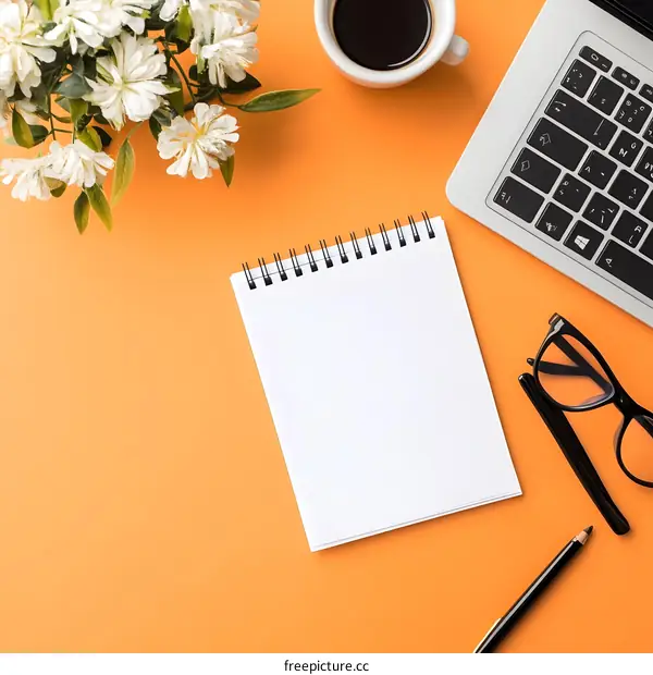 Flat Lay Minimalist Workspace Orange Background  with Notebook Laptop Coffee and Flowers