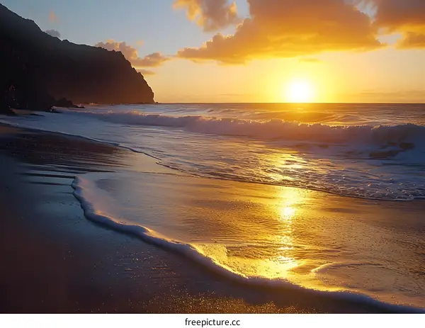 The setting sun casts a golden glow on the beach
