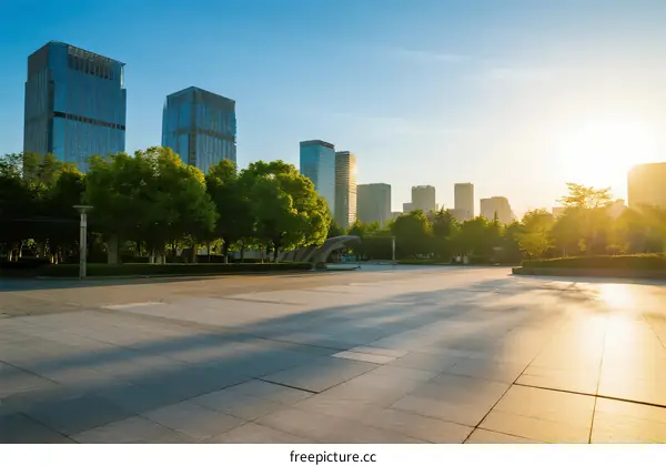 Sunlit urban square with modern skyscrapers in the background