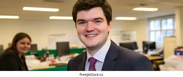 Smiling Businessman in Office Setting