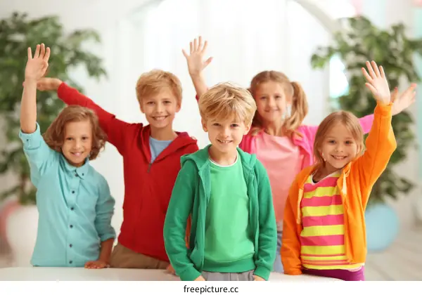 Group of Children Raising Hands in Happy Pose