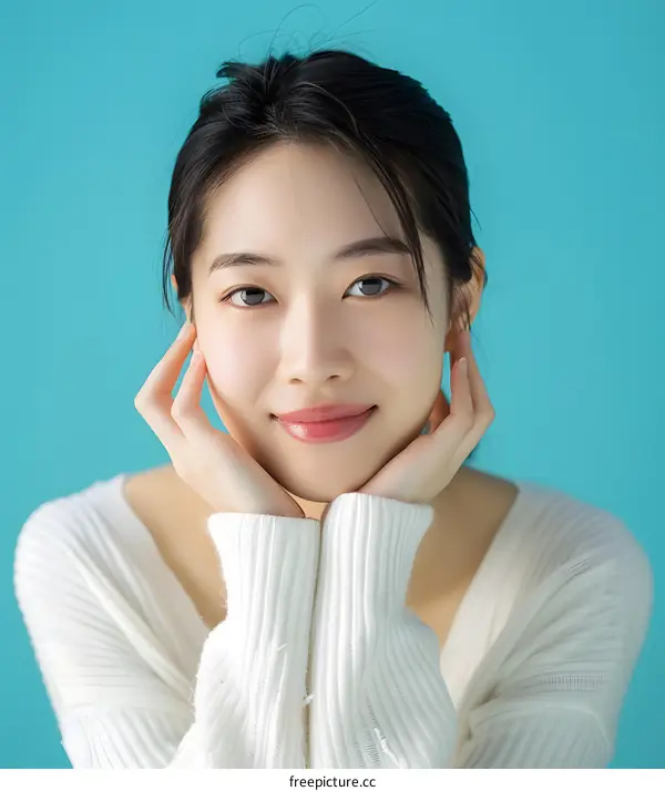 Smiling Asian Woman Portrait Against Blue Background