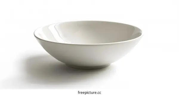 An empty white bowl sits on a white table against a white background