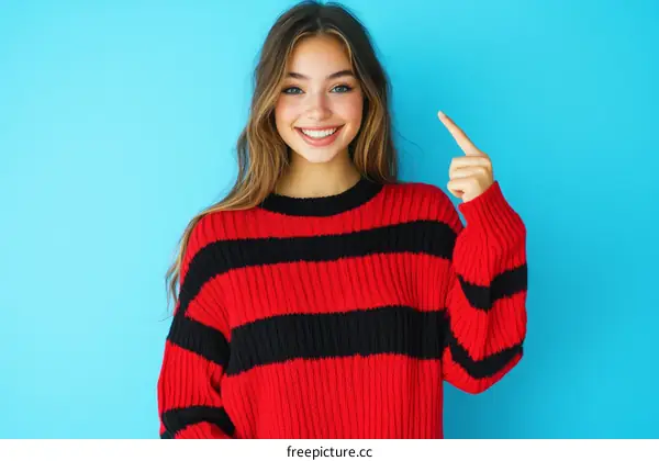 Smiling Teenage Girl in Red and Black Striped Sweater