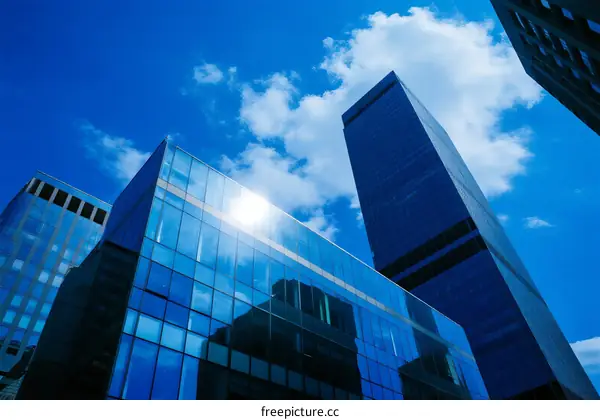 Modern Glass Skyscrapers Under Blue Cloudy Sky