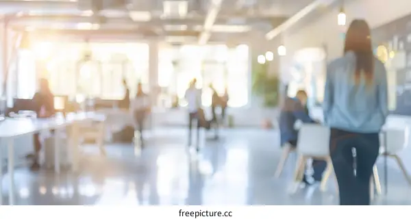 Blurred image of people walking in an office