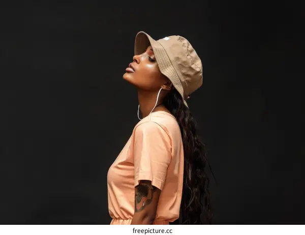 A young woman wearing a hat looking away from the camera