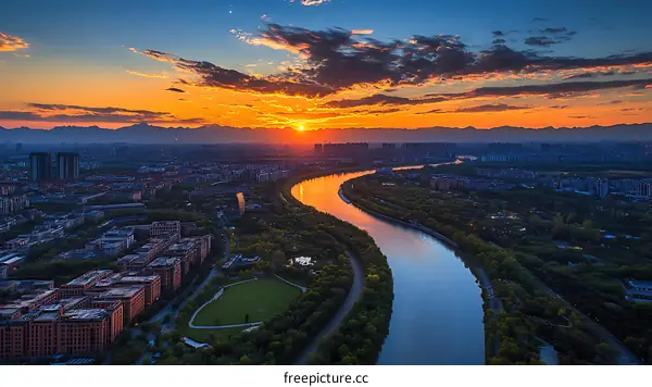 Cityscape Sunset over a Winding River
