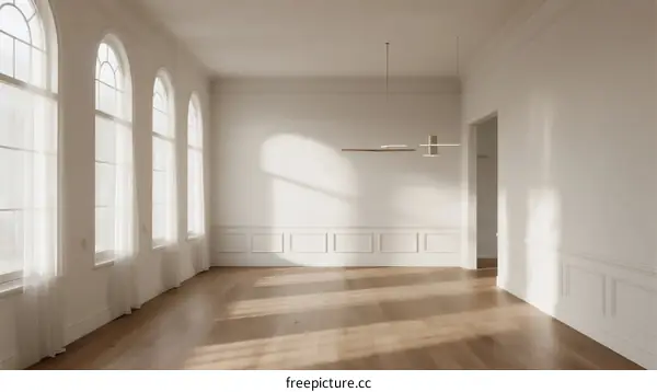 Bright and spacious room with large windows and wooden floor