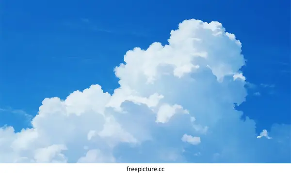 Fluffy White Cumulus Clouds Against Clear Blue Sky