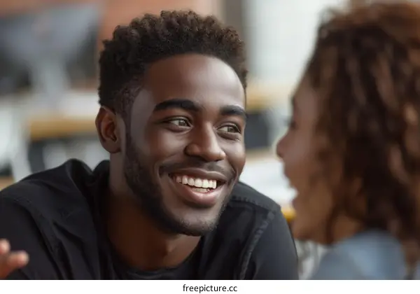 Smiling African American man looking at a woman