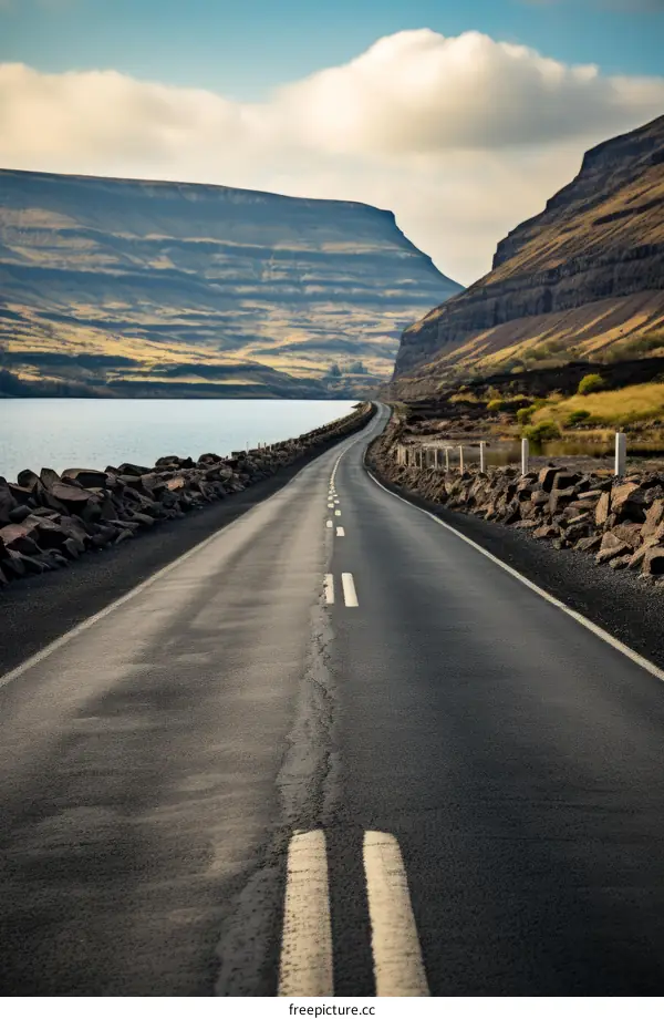 Road through a valley with mountains in the background