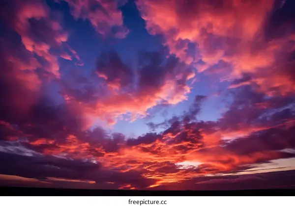 A vivid sunset sky with vibrant hues of pink, orange, and blue