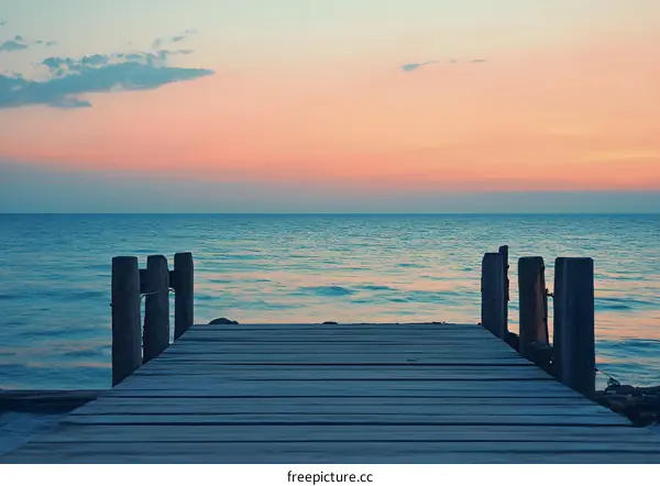 Wooden Pier Overlooking the Ocean at Sunset