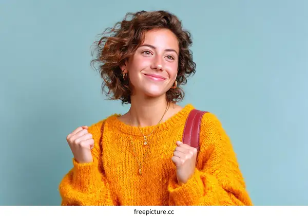 Happy Woman in Yellow Sweater with a Red Backpack