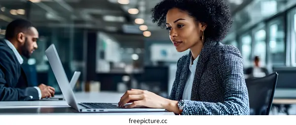 African American Woman Working On Laptop In Office