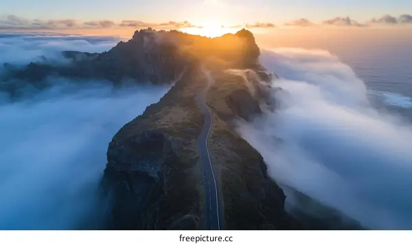 Sunrise over Mountain Road through Cloudscape