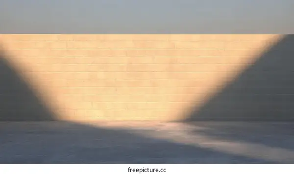 Sunlight Casting Shadow on Light Beige Brick Wall