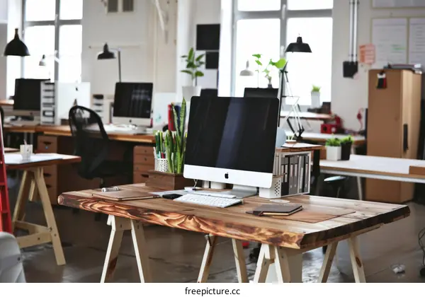 Modern open space office interior with wooden table and iMac computer