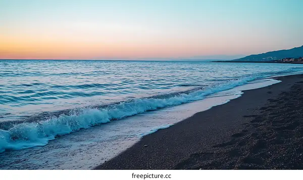 Peaceful Ocean Sunset with Blue Water and a Sandy Beach