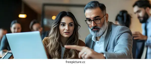 Business Professionals Working Together on Laptop in Office