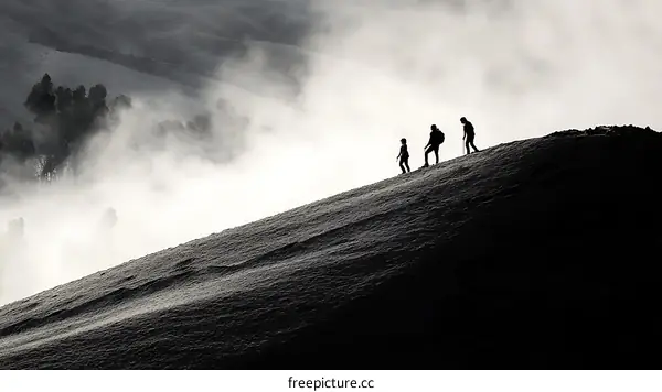 Misty Mountain Ascent Silhouette of Hikers