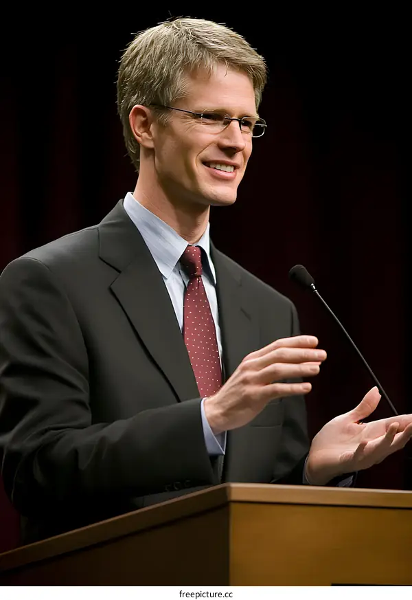 Man in Suit Speaking at a Podium