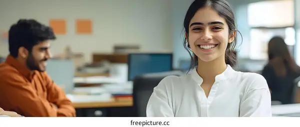 Smiling Woman with Folded Arms in Office Setting