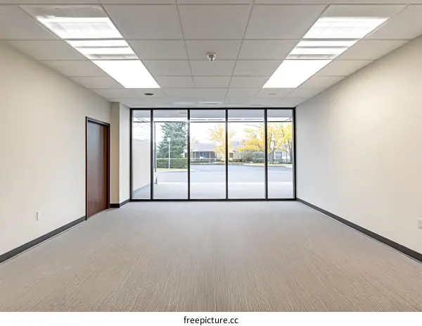 Empty Office Room with Large Window View of Building Exterior