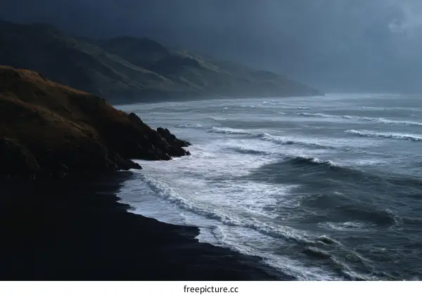 Dark Beach Meets Rough Ocean Waves