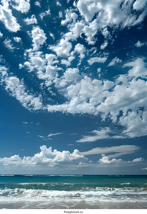 Beautiful Blue Sky with White Fluffy Clouds Over a Tranquil Beach