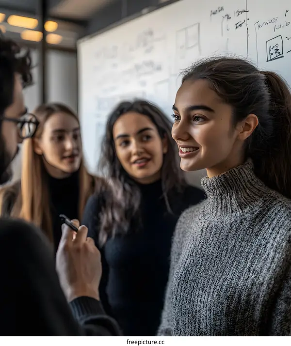Group of young people discussing a project on a whiteboard