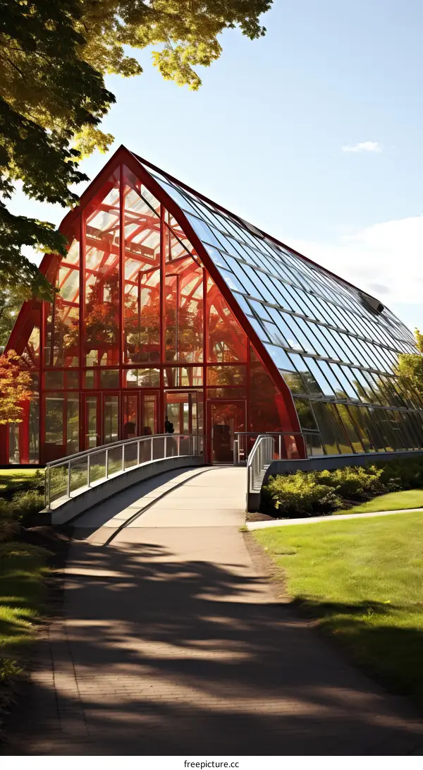 Modern Glass and Steel Building with Red Frame and Green Roof