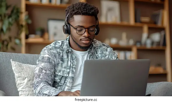 Young African Man Working on Laptop at Home