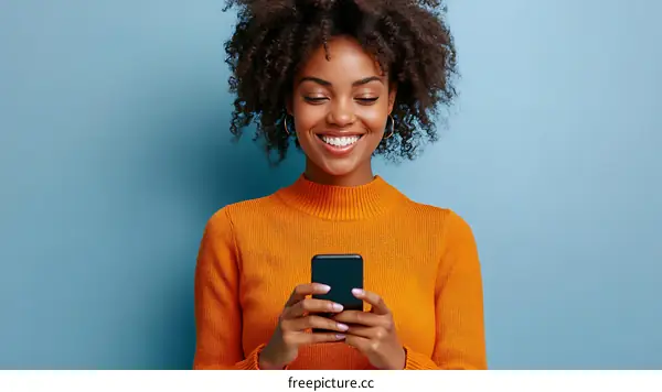 Smiling Woman using Mobile Phone on Blue Background