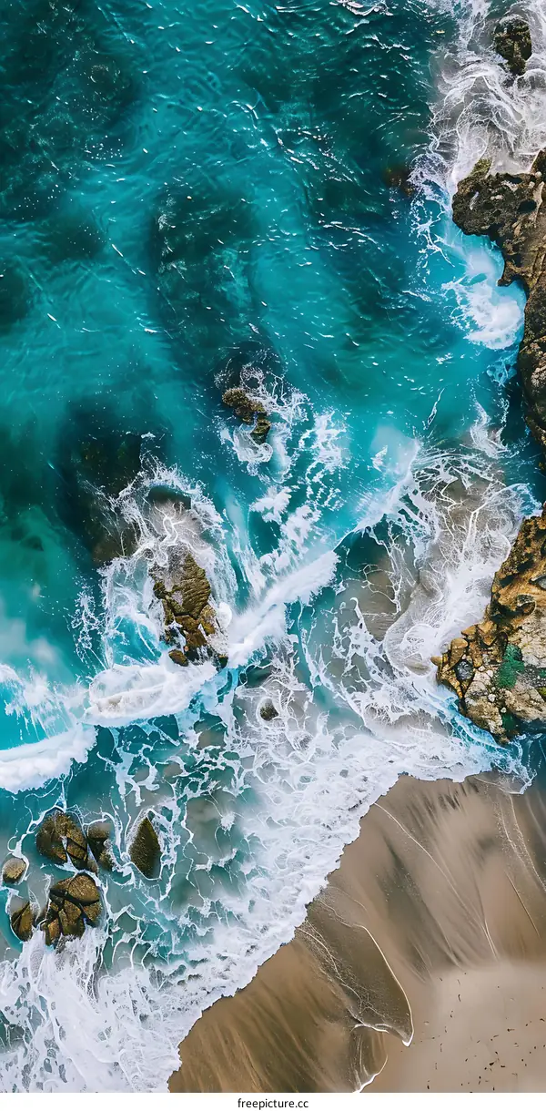 Aerial View of Ocean Waves Crashing on Sandy Beach