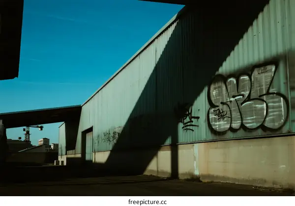 Urban Industrial Building with Graffiti and Clear Blue Sky