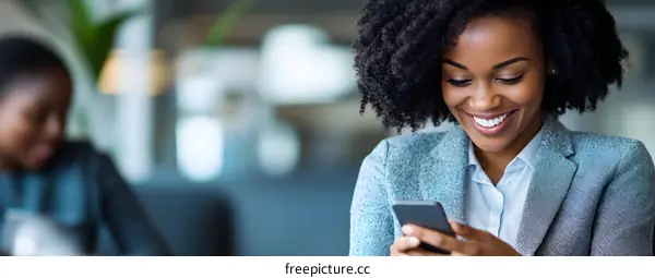 Smiling African American Businesswoman Using Smartphone
