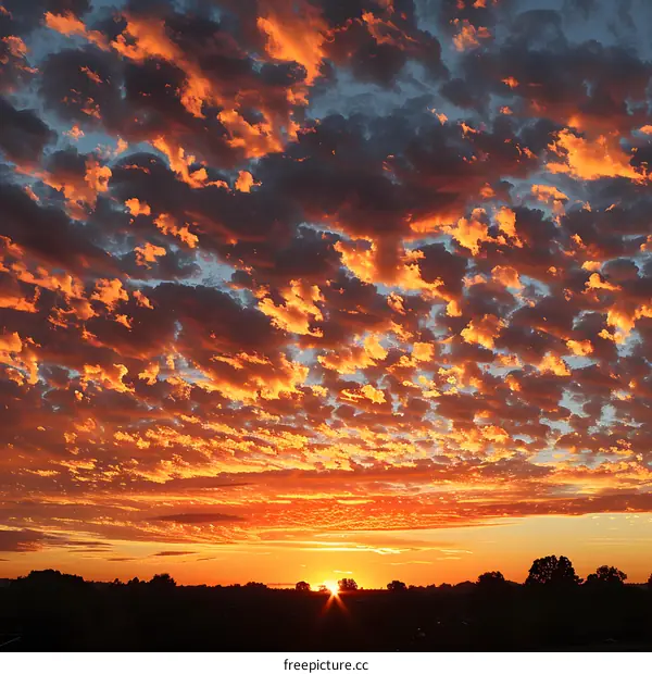 A setting sun casts a golden glow on the clouds