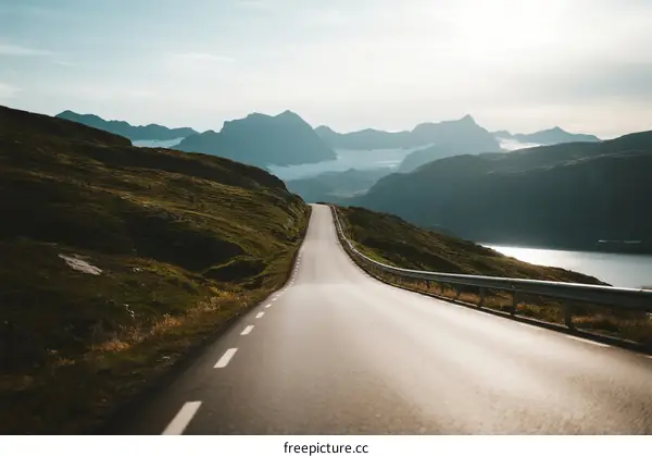 Scenic road winding through mountains with a lake in the distance