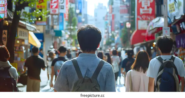 Man Walking Through Busy Street in Japan
