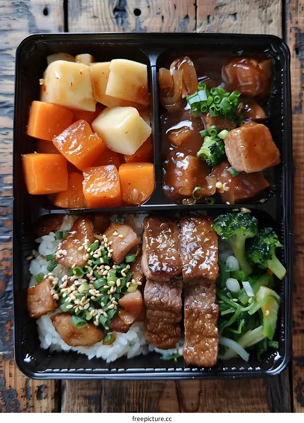 A delicious and healthy bento box with rice, beef, vegetables and potatoes