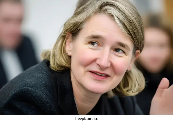 Portrait of a Smiling Blonde Woman in a Meeting