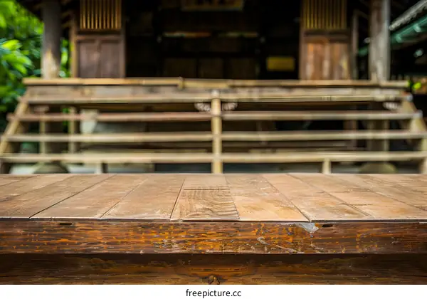 Wooden Table In Front Of Blurred Japanese House