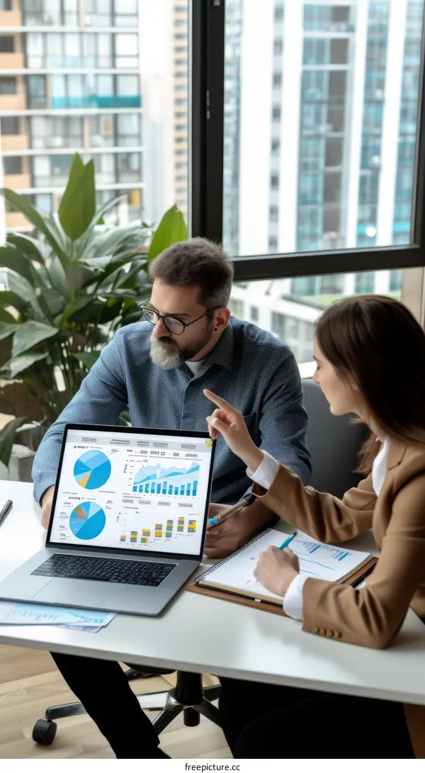 Two business people discussing financial data on a laptop computer