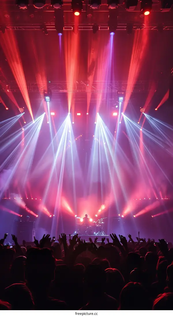 Rock concert stage with crowd and bright lights